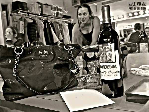 Once you see “Maple and Vine,” you’ll know why Mad Housewife wine was such an appropriate opening-night gift from actor C. Kelly Leo, left, to castmate Karen Slack. Photo by John Moore. 