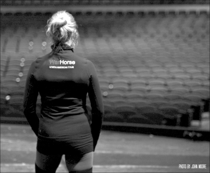 A cast member takes a moment to prepare and reflect moments before the audience is allowed into the Buell Theatre. Photo by John Moore.  