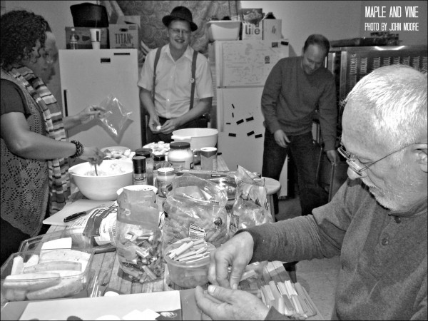 Curious Theatre company members Jada Roberts, Brian Landis Folkins, Josh Hartwell and Jim Hunt meets hours before the opening performance to prepare food for the eventual afterparty. Photo by John Moore. 